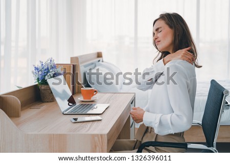 young women neck and shoulder pain injury with red highlights on pain area, healthcare and medical concept  Royalty-Free Stock Photo #1326396011