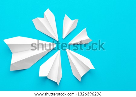 white paper airplane on a blue background