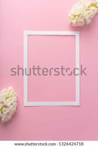white frame on a pink background with hyacinths, free space