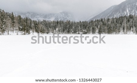 Snowfall on the Fusine lakes. Ghaccio and enchanting snow. Tarvisio, Friuli