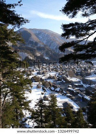 Landscape picture, small village in the middle of a snowy valley, shirakawago