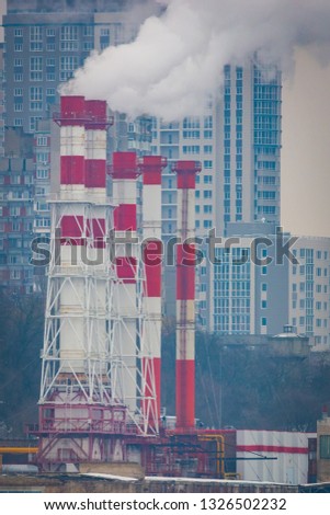 Air Pollution From Industrial Plants. Smoking industrial pipes. Red with white pipe