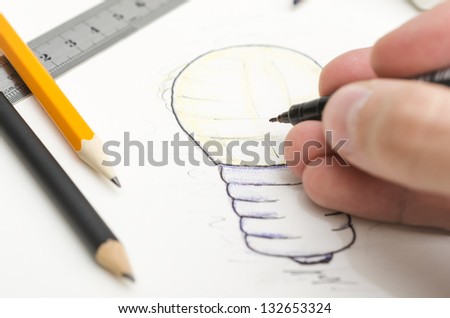 Designer drawing a light bulb