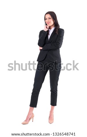 Confident successful business woman with folded arms smiling at camera. Full body isolated on white background. 