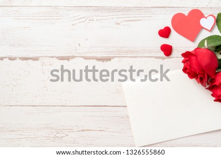 Greeting concept - Beautiful roses and hearts shape with white empty card isolated on a bright wooden table, copy space, flat lay, top view, mock up