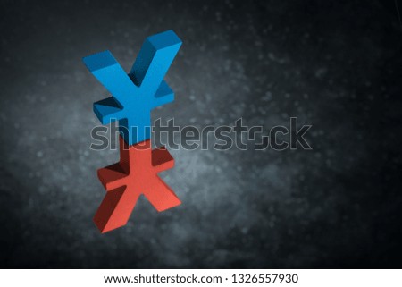 Red and Blue Japanese of Chinese Currency Symbol Yen or Yuan With Mirror Reflection on Dark Dusty Background