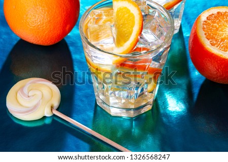 Summer mood, a glass of water and ice with orange slices