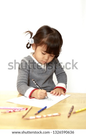 Japanese girl drawing a coloring book (4 years old)
