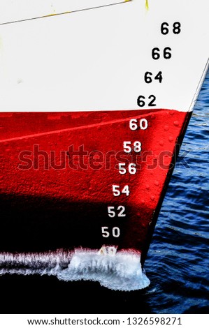 Red and white frozen ship prow close up