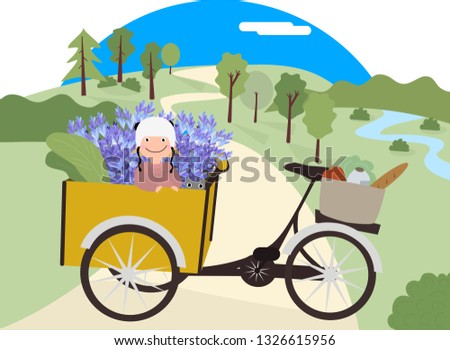 Baby girl on a bicycle carrier with a cat