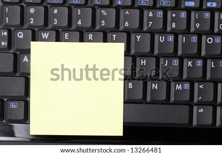Blank Yellow Note On Black Laptop Keyboard