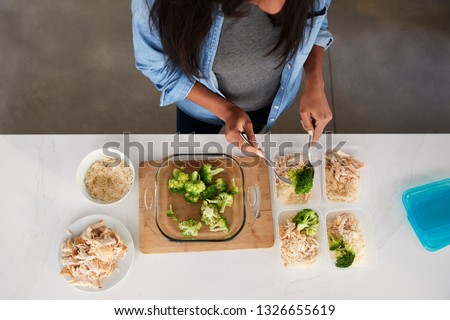 Overhead View Of Woman In Kitchen Preparing High Protein Meal Royalty-Free Stock Photo #1326655619