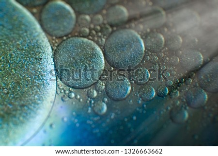 Macro blue oil bubbles in water