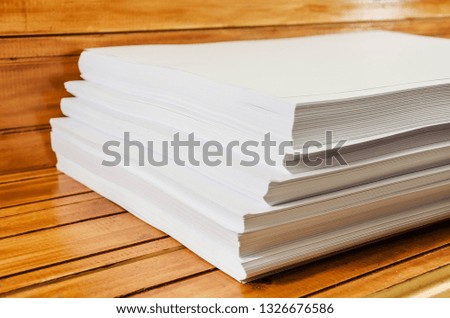  bunch of white paper on a brown, wooden background