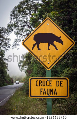Animal Crossing traffic sign on Interamericana Highway (Route 2). Wildlife corridor through cloud forest of the Talamanca Mountains Range in Costa Rica