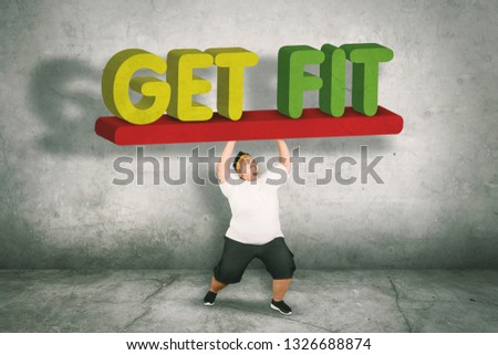Picture of an obese man wearing sportswear while lifting text of get fit 
