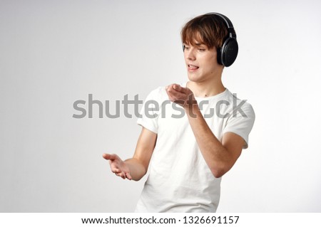 Cute guy in headphones listening to music DJ dancing