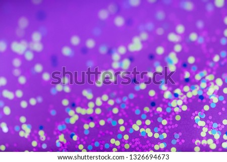 festive blured textured background of colorful party confetti