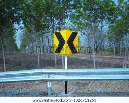 A traffic sign somewhere in a country side road. 