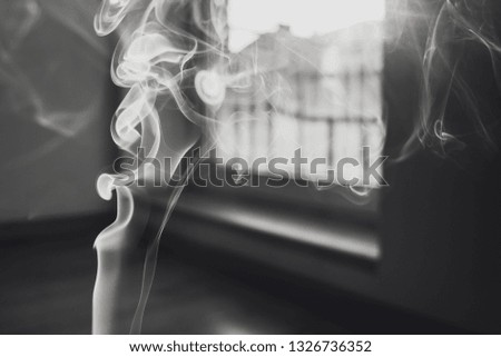 Abstract image of smoke from incense stick, closeup view. Edited in black and white