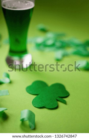 Patricks Day Concept On Green Background. Beer and Leprechaun Hat with Confetti