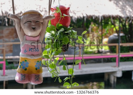 decoration of clay doll hanging with tree