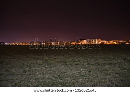 Night skyline with open fields over the city