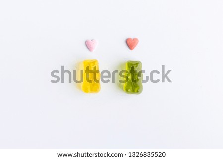 romantic gummy bears with hearts on the head on white background