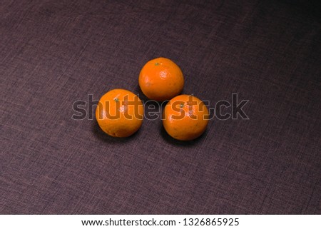 Three ripe Mandarin on table