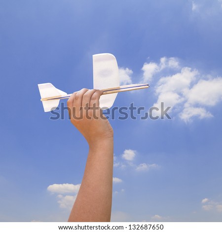 Kid hand holding a model airplane