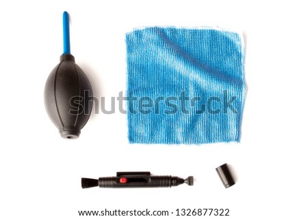 Cleaning kit for camera lenses on a white background, photographer accessories, professional lenses cleaning service.