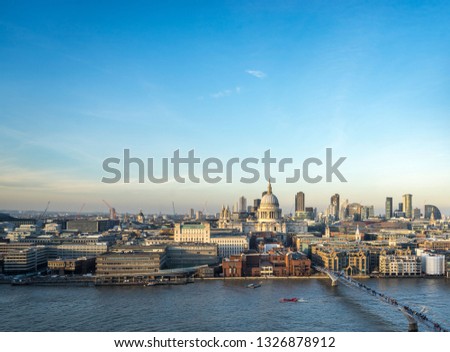 St. Paul’s Cathedral and the London skyline on a clear sunny day with River Thames in the foreground