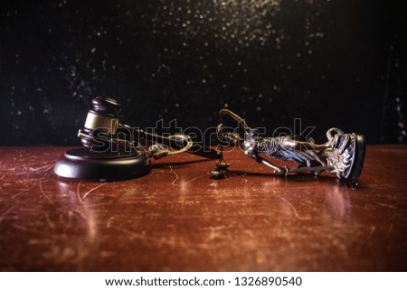 Law theme, mallet of the judge on wooden desk with Lady Justice Statue. Concept For Corruption, Justice, Law, Bankruptcy Court, Bail, Crime, Bribing, Fraud. Law gavel with handcuff and money