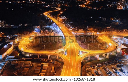 Aerial View Above of Busy Highway Road Junctions at Night. The Intersecting Freeway Road Overpass. Sochi, Russia