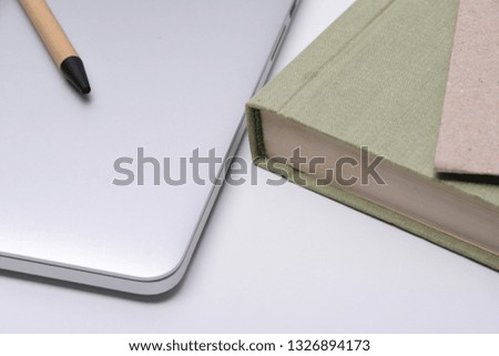 Desk with laptop, books and business pen