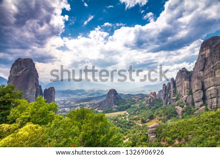 The Meteora with dramatic overcast sky, a rock formation hosting built complexes of monasteries,  Greece, Europe.