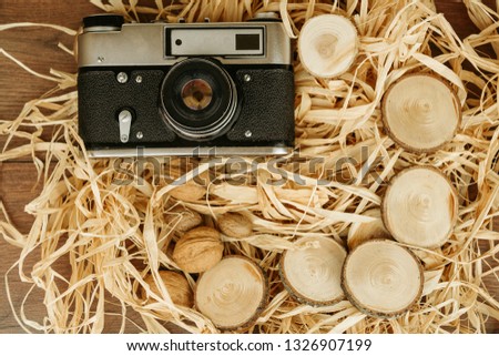Old camera lying on a wooden table