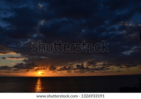 Brilliant and Stunning Orange and Purple Caribbean Sunset with Clouds and Sky over the Sea