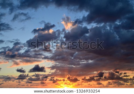Brilliant and Stunning Orange and Purple Caribbean Sunset with Clouds and Sky over the Sea