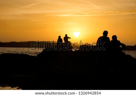 People enjoying the sunset at Essaouira beach in Morocco