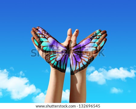 Hand and butterfly hand painting, tattoo, over a blue sky,  concept for spiritual symbol of soul Royalty-Free Stock Photo #132696545