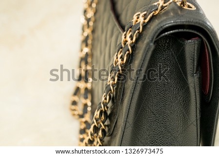 Photo of black handbag on the table.