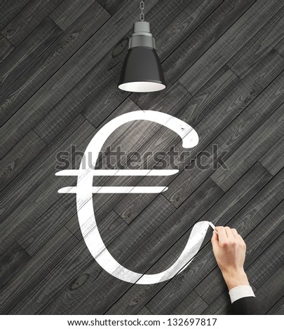 hand drawing euro sign on wooden wall
