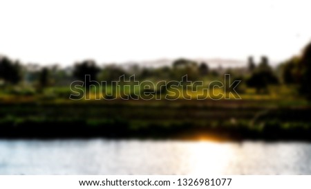 The river is lined with trees and rocky shoreline with blurred movements.