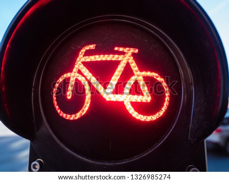 Bright red traffic light or signal lamp to control urban traffic flow on streets and protect people showing bike indicating cyclists to stop on road crossing in Nuremberg, Bavaria, Germany