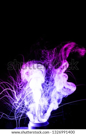 Vape clouds splash isolated on black background. Two colours fog is blue and purple. Stock color smoke photo with spray boiling glycerine.