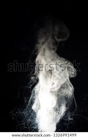 Column of vape clouds splash on black background. A lot of lines of smoke. White fog is tight. Stock isolated white smoke with spray boiling liquid.
