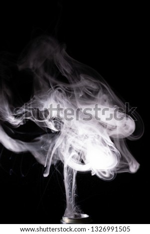 Vape clouds splash on black background. Stock isolated white smoke with spray boiling glycerine.