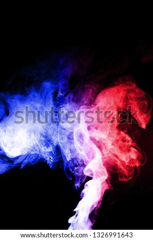 Colorful cloud splash with spray boiling liquid. Two colours fog is hue blue and hue red. Stock photo isolated on black background.