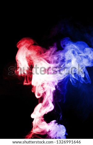 Column of vape clouds splash on black background. A lot of lines of smoke. Two colours fog is blue and red. Stock isolated color smoke with spray boiling liquid.